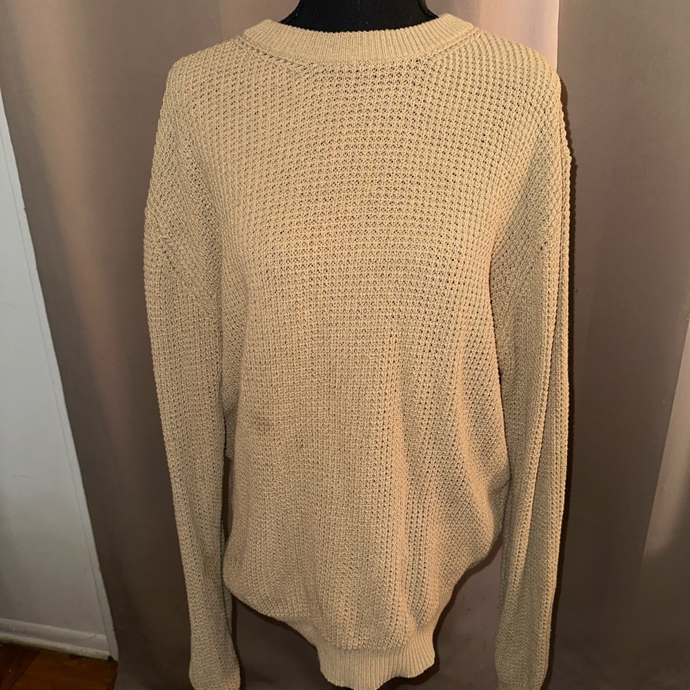 Basic tan sweater. Can be styled versitaly. Looks a little worn.